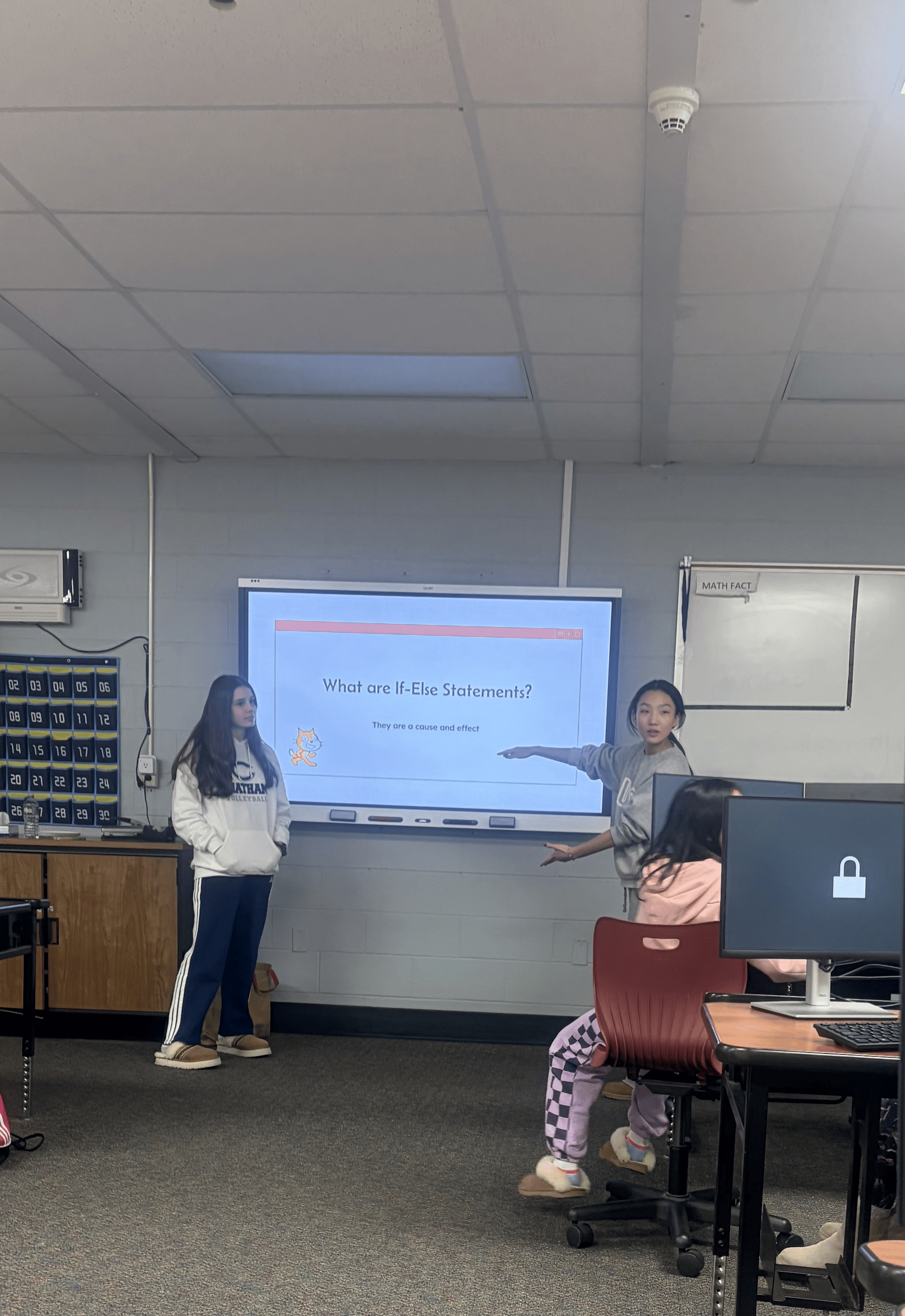 Volunteers teaching If-Else Statements on the smart board
