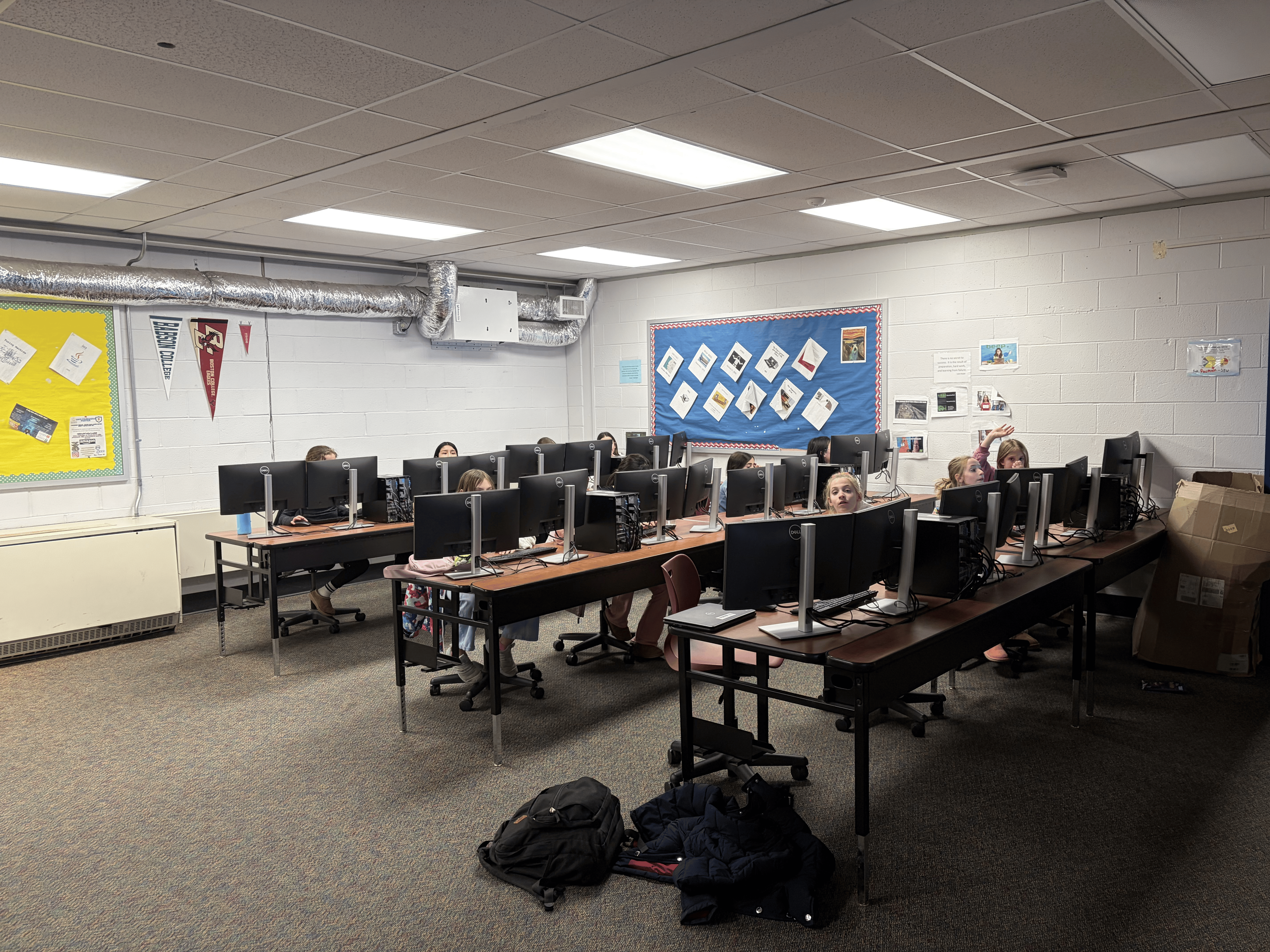 Elementary school girls working at computers in class