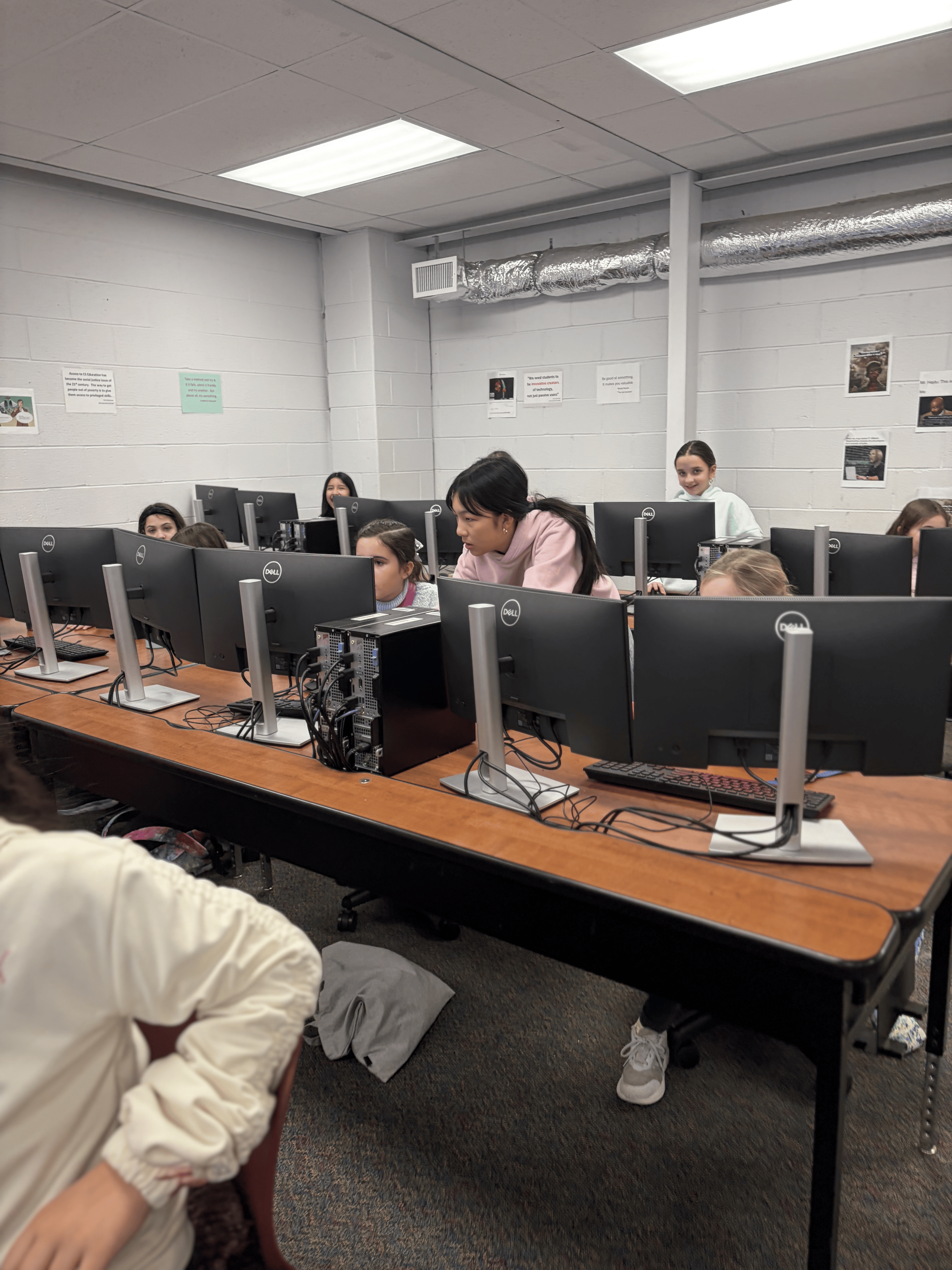 Volunteer helping a student at her computer