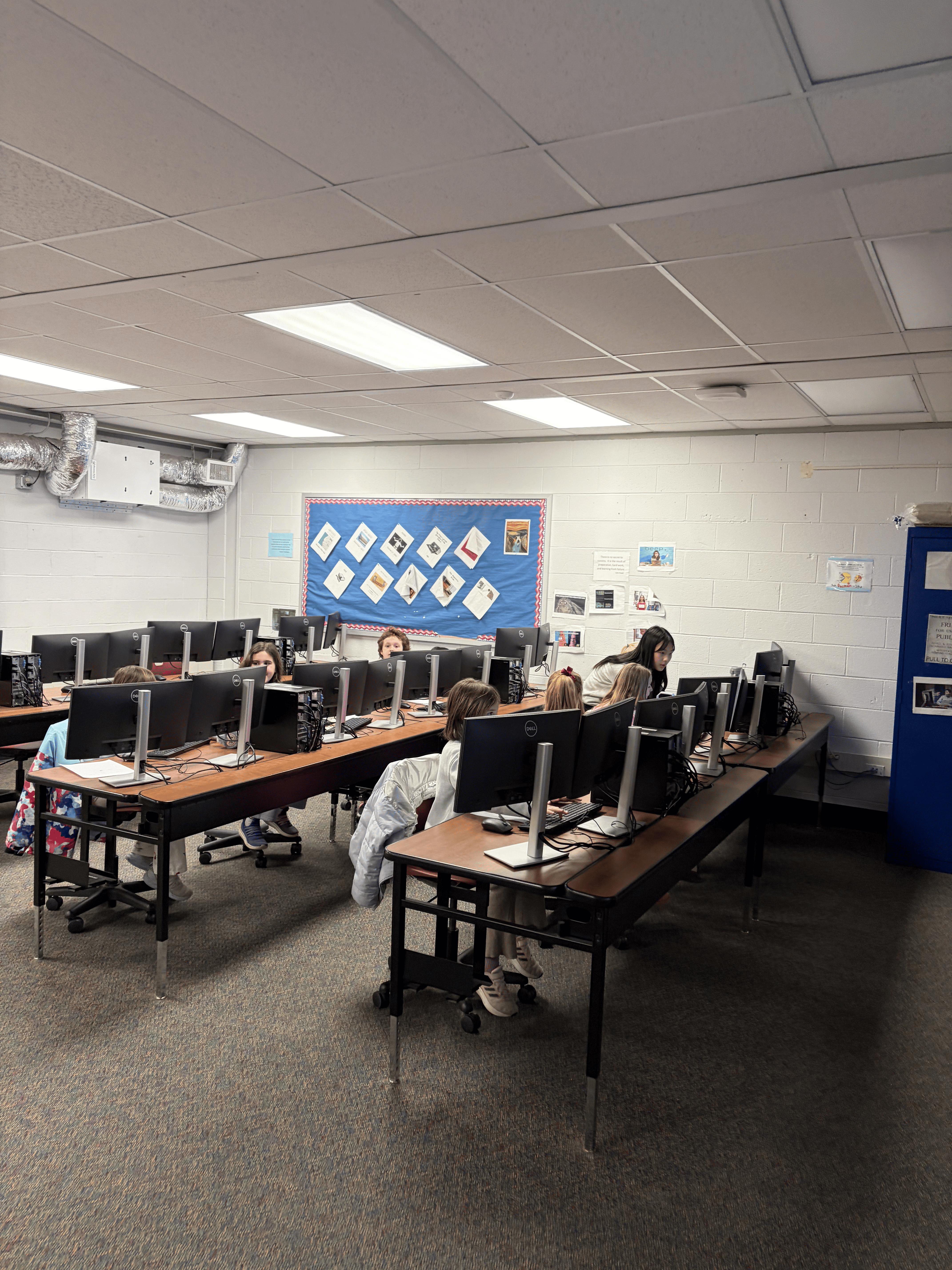 Wide view of students working in the computer lab